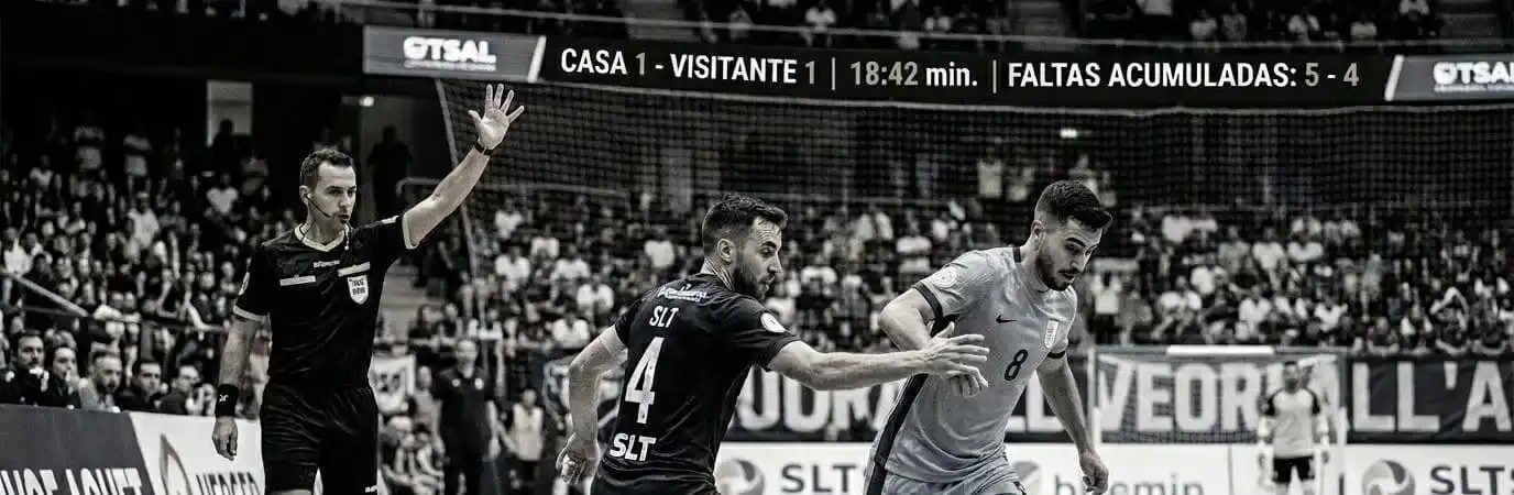 Futsal players in intense dispute on an indoor court