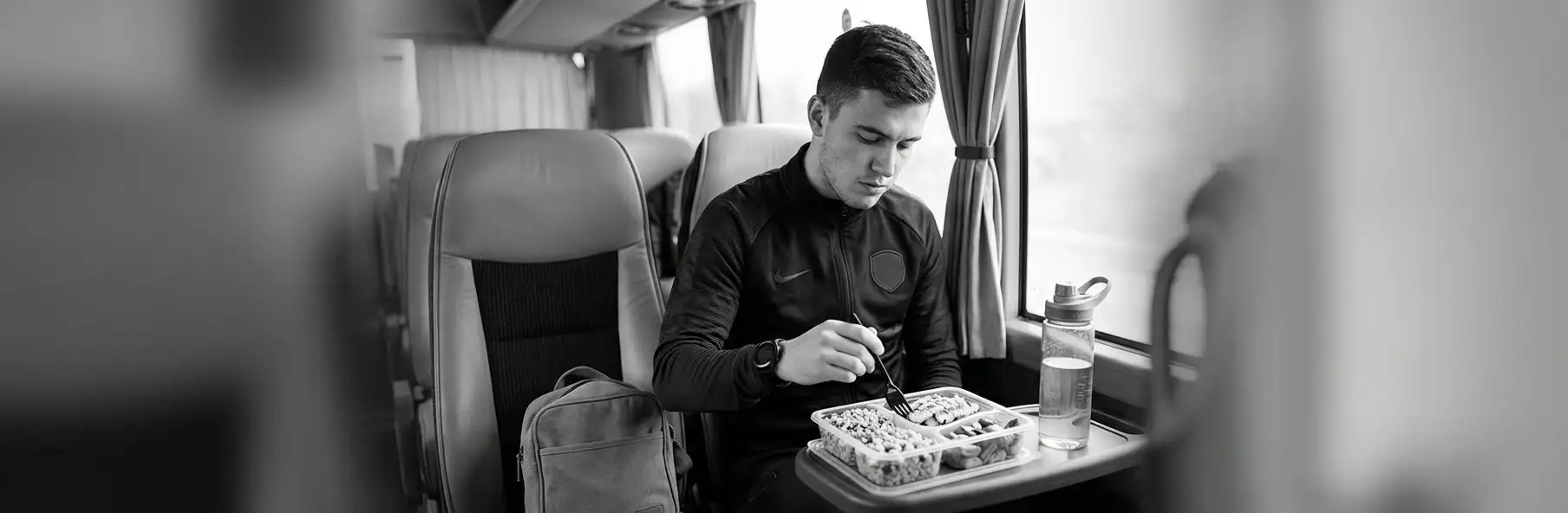 Football players eating a meal before an away match