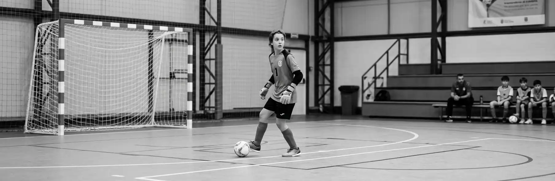 Futsal goalkeeper playing as an outfield player beyond the area during a youth training session