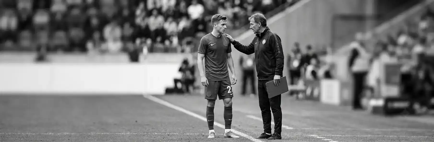 Young football player stepping onto the pitch for the first time with the first team