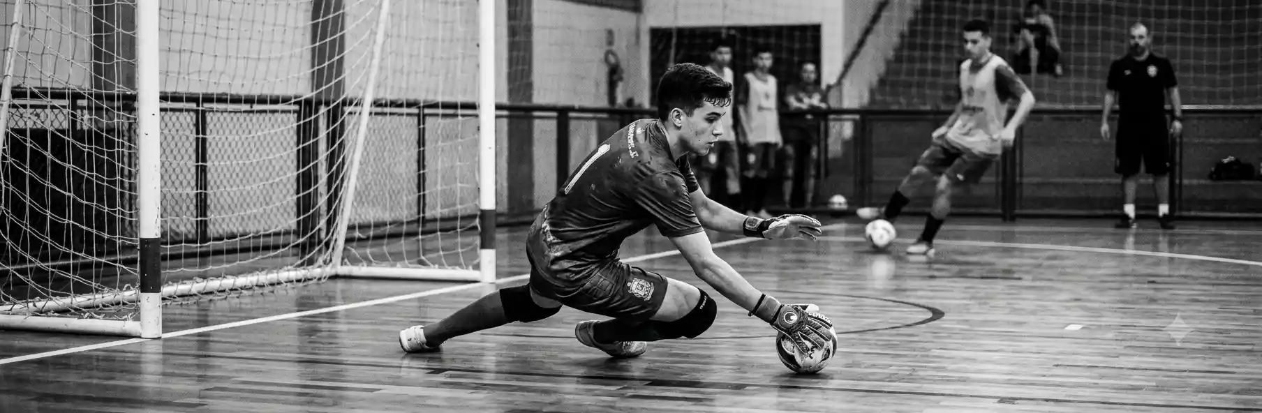 Futsal goalkeeper saving a shot during a specific training session