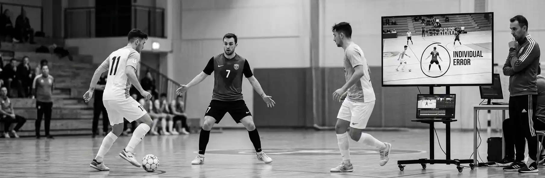 Futsal winger in defensive man-marking position against a direct opponent