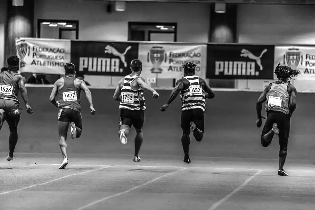 Athlete running on a track at sunset