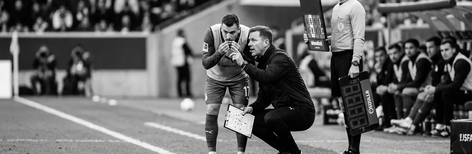 Football substitute warming up on the touchline before coming on