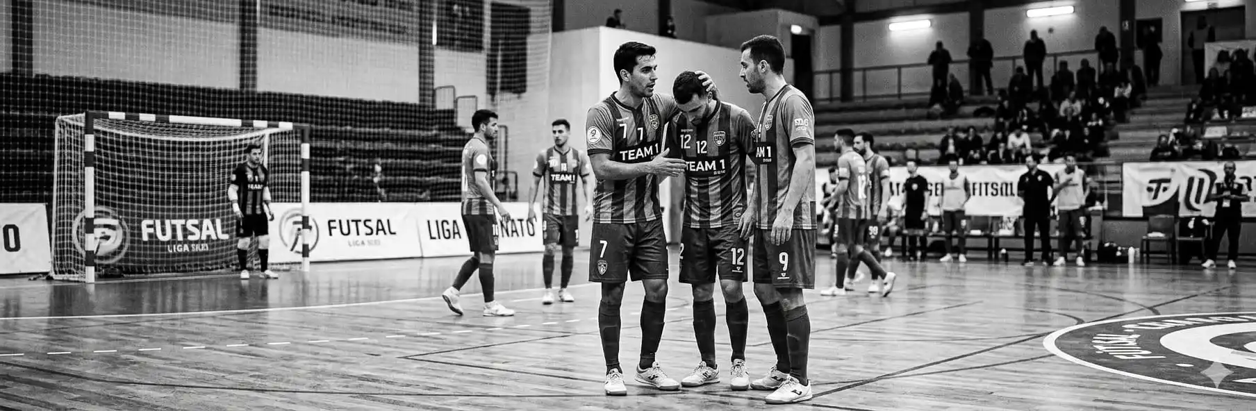 Futsal coach mediating a conversation with players in the changing room