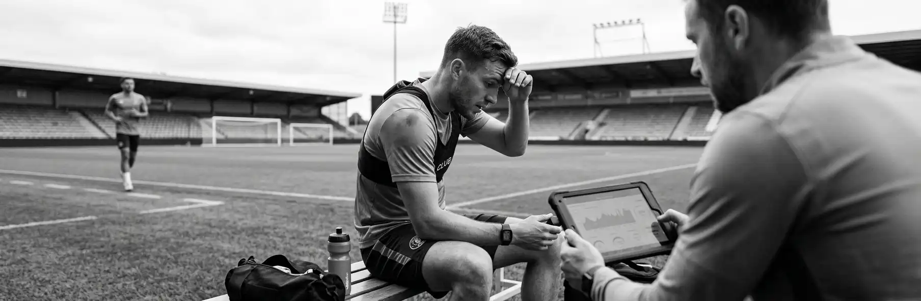 Elite football coaching staff analysing GPS and training load data