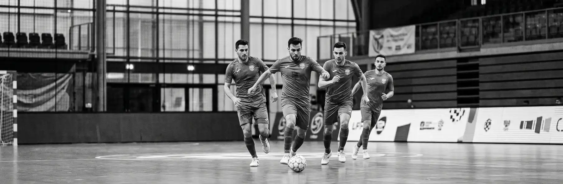 Elite futsal coaching staff analysing load data by quartet