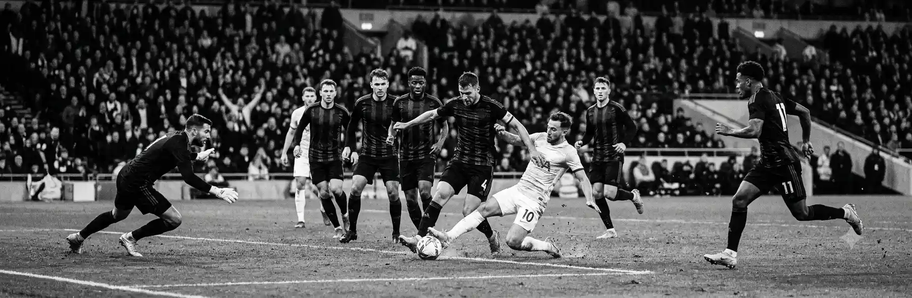Compact football team defending in a low block near their own box