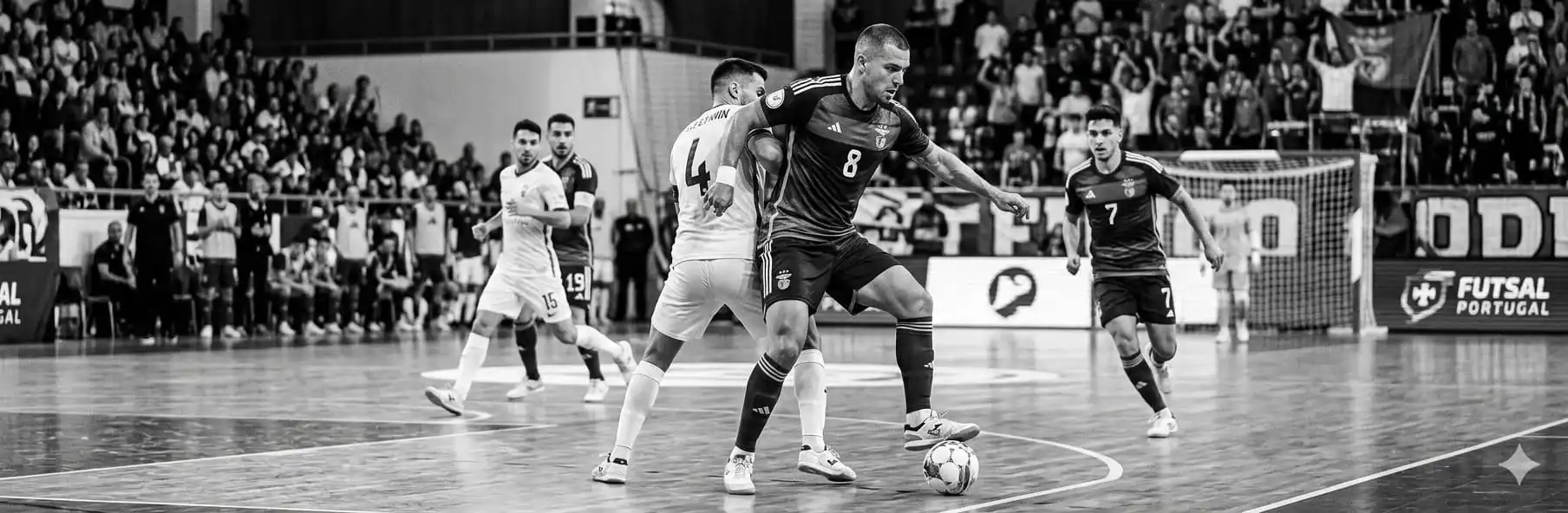 Futsal pivot with back to goal protecting the ball