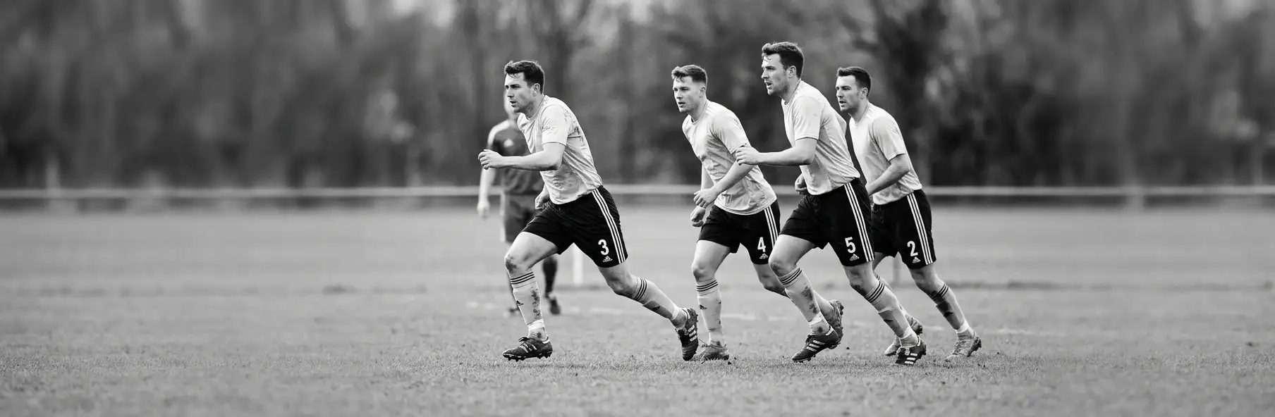 Football back line executing an offside trap