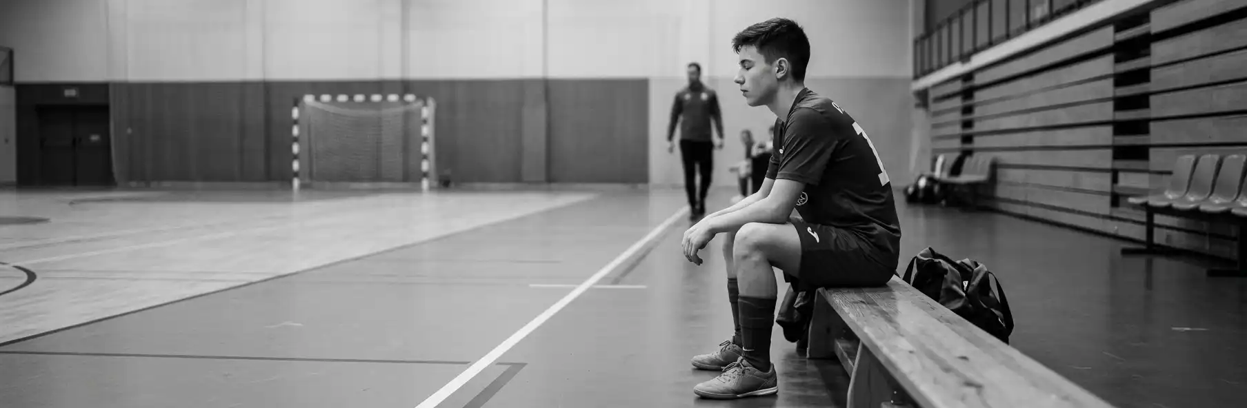 Young futsal player focused in the changing room before the match