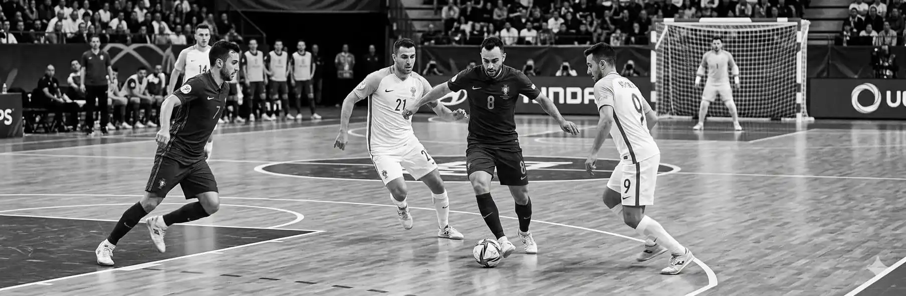Futsal coach drawing movements on a tactical board against a zone defence